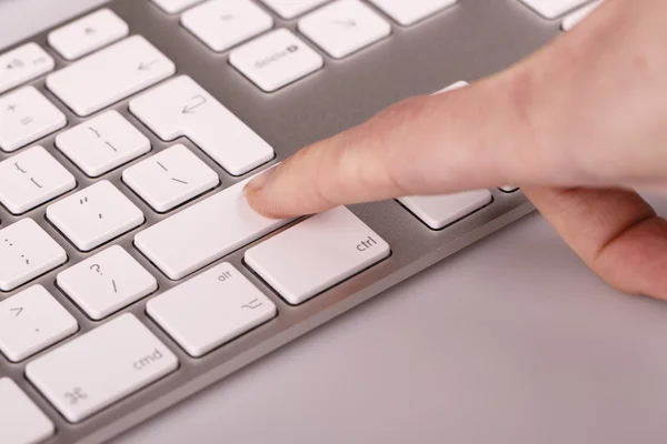 Silver keyboard with woman finger — Stock Photo, Image