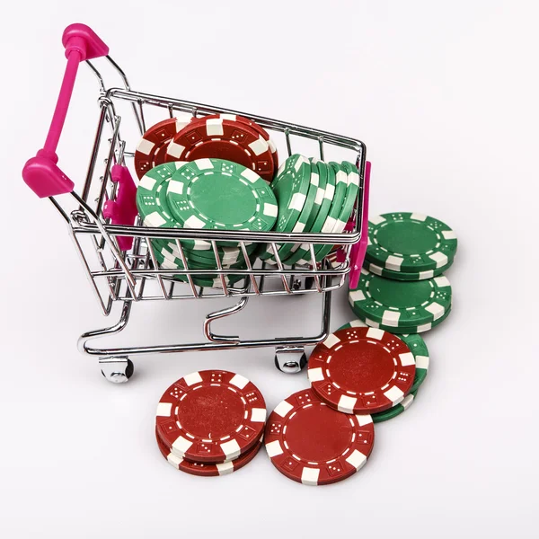Shopping cart with casino chips over white — Stock Photo, Image