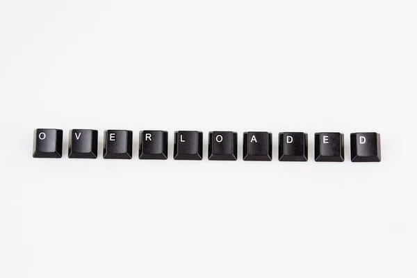 Υπερφορτωμένο λέξη που γράφεται με μαύρο υπολογιστή κουμπιά πάνω από λευκό — Φωτογραφία Αρχείου