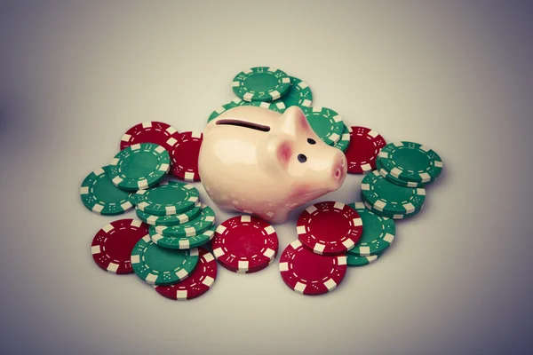 Pig money box with casino chips over white — Stock Photo, Image