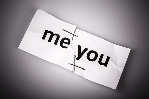 "ME YOU "words written on torn and stapled paper — стоковое фото