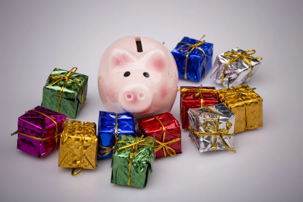 Pig money box between christmas gift — Stock Photo, Image