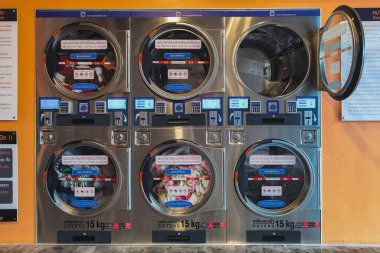 CHACHOENGSAO,THAILAND-JANUARY 3,2021 : View of laundry service shop with automatic washer dryer is available to general customers 24 hours a day at Maroom loundry shop. Cloth cleaning business concept