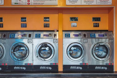 CHACHOENGSAO,THAILAND-JANUARY 3,2021 : View of laundry service shop with automatic washer dryer is available to general customers 24 hours a day at Maroom loundry shop. Cloth cleaning business concept