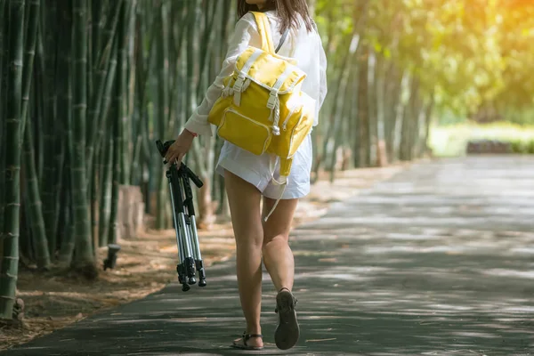 Back View Young Woman Photo Backpack Holding Tripod Walks Alone — Stock fotografie