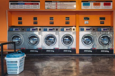 CHACHOENGSAO,THAILAND-JANUARY 3,2021 : View of laundry service shop with automatic washer dryer is available to general customers 24 hours a day at Maroom loundry shop. Cloth cleaning business concept