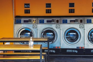 CHACHOENGSAO,THAILAND-JANUARY 4,2021 : View of laundry service shop with automatic washer dryer is available to general customers 24 hours a day at Maroom loundry shop. Cloth cleaning business concept