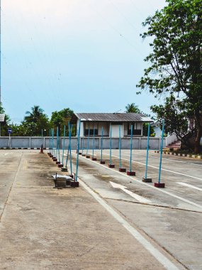 Driving test and training area with simulate test for driving license. Driving school practice traffic area with pole signs and orange cones and road signs for safety on concrete road. Selective focus.