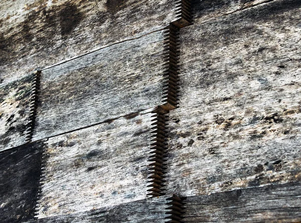 Close up to old dirty finger joint at end of wood sticks. Woodworking of zigzag at end of the pieces for splicing. Splicing wood. Technique called Finger joint wood connection. Top view as background.