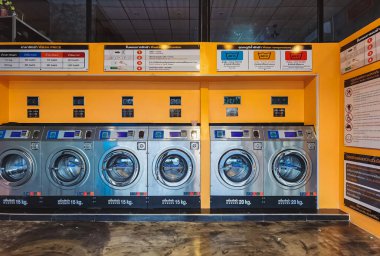 CHACHOENGSAO,THAILAND-JANUARY 3,2021 : View of laundry service shop with automatic washer dryer is available to general customers 24 hours a day at Maroom loundry shop. Cloth cleaning business concept