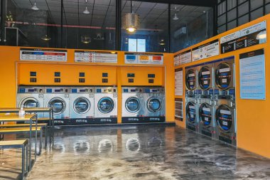 CHACHOENGSAO,THAILAND-JANUARY 4,2021 : View of laundry service shop with automatic washer dryer is available to general customers 24 hours a day at Maroom loundry shop. Cloth cleaning business concept