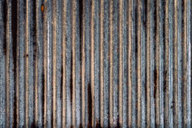 Eski ve paslı çinko çarşaf duvarının artistiği. Klasik stil metal yaprak çatı dokusu. Eski metal levha deseni. Paslı metal ya da yanlamasına. Galvanizasyon aşınması. Geçmiş kavramında arkaplan ve doku