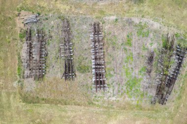 Atılmış eski demiryolu rayları ve arazide çürümeye bırakılmış keresteciler. Yukarıdan aşağıya hava görüntüsü.