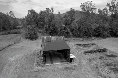 Tarihi demir bakım ve şeker değirmeninin monoton bir park manzarasında eski demiryolu rayları yan tarafında yığılı