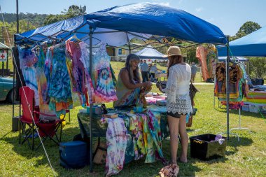 Eungella, Queensland, Avustralya - Ekim 2021: Kadınlar bir köy panayırında çadırda giysi satıp satın alıyorlar