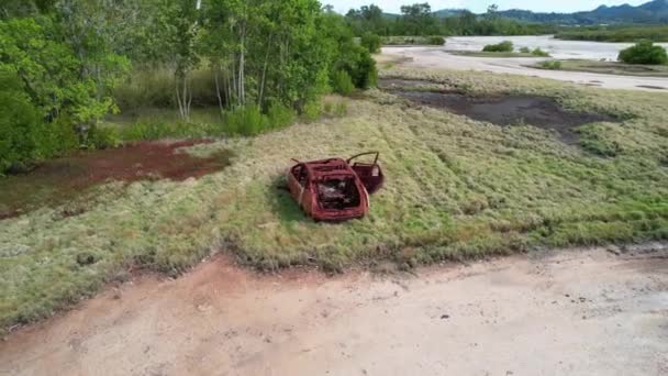 Drone Aerial Rusting Illegally Dumped Car Wreck Tidal Salt Pans — Stock Video