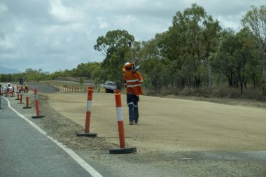 Bruce Highway Townsville 'den Mackay' e, Queensland, Avustralya - Kasım 2021: İş yerinde ekipman taşıyan yol işçisi