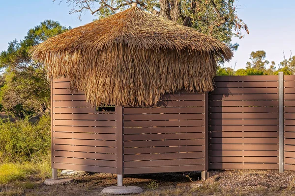 A bird hide at the Sapphire Wetlands Reserve in Queensland, Australia. Timber and straw building for watching birds.