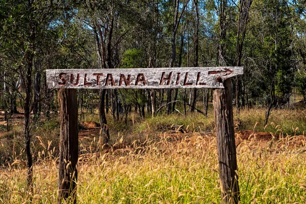 Sultana Hill hand carved sign in the bush at Rubyvale Australia.