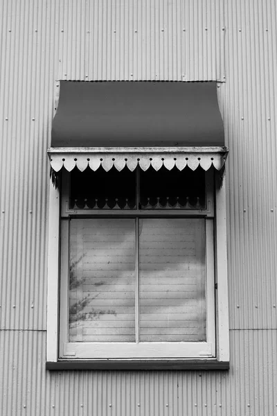 Close up of the window and red iron awning of a heritage listed historical homestead