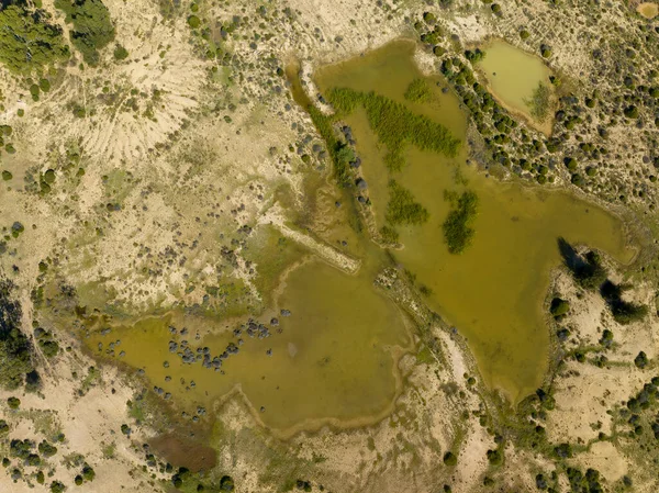 stock image Drone aerial view looking down over sapphire mine diggings with water reservoir in central Queensland Australia.