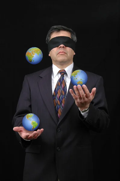 Businessman juggling with planet earth — Stock Photo, Image