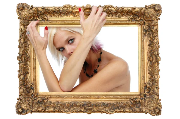 Beautiful blond lying on a gold frame — Stock Photo, Image