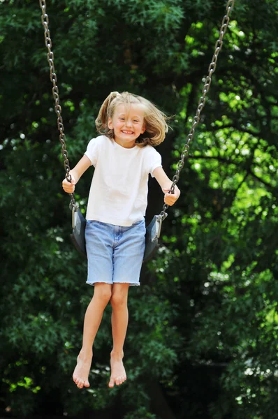 Little girl swinging — Stock Photo, Image