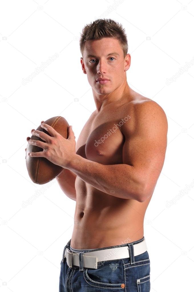 Muscular young man holding a football