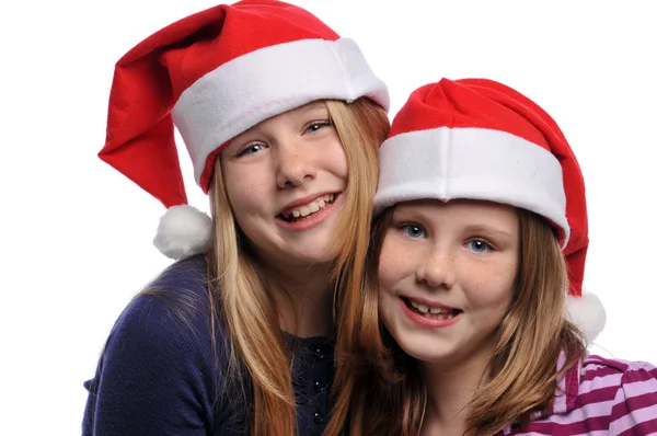 Two girls wearing Christmas hats — Stock Photo, Image