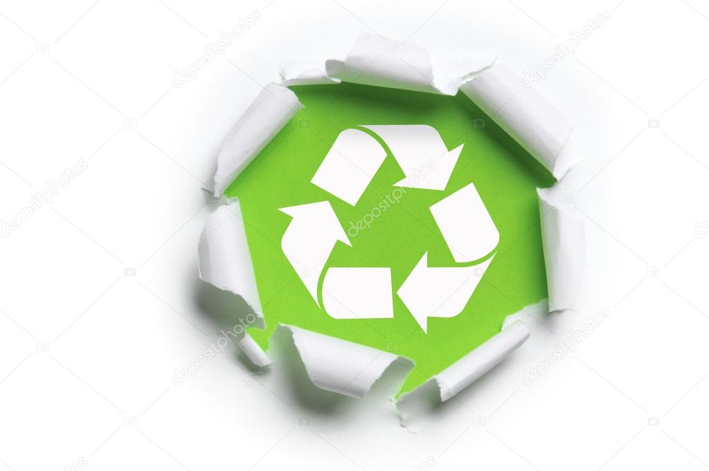 Ripped white paper with recycle logo against a green background