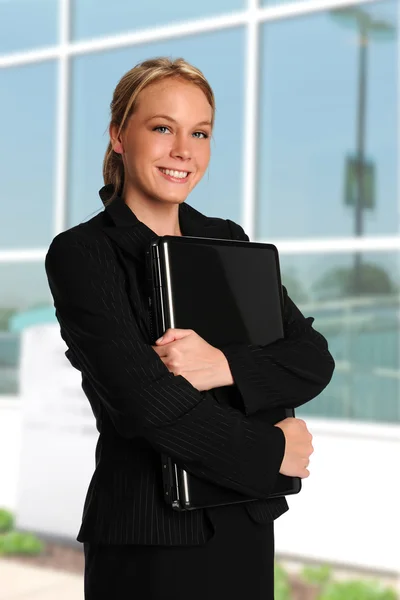 Young businesswoman holding a laptop — Stock Photo, Image