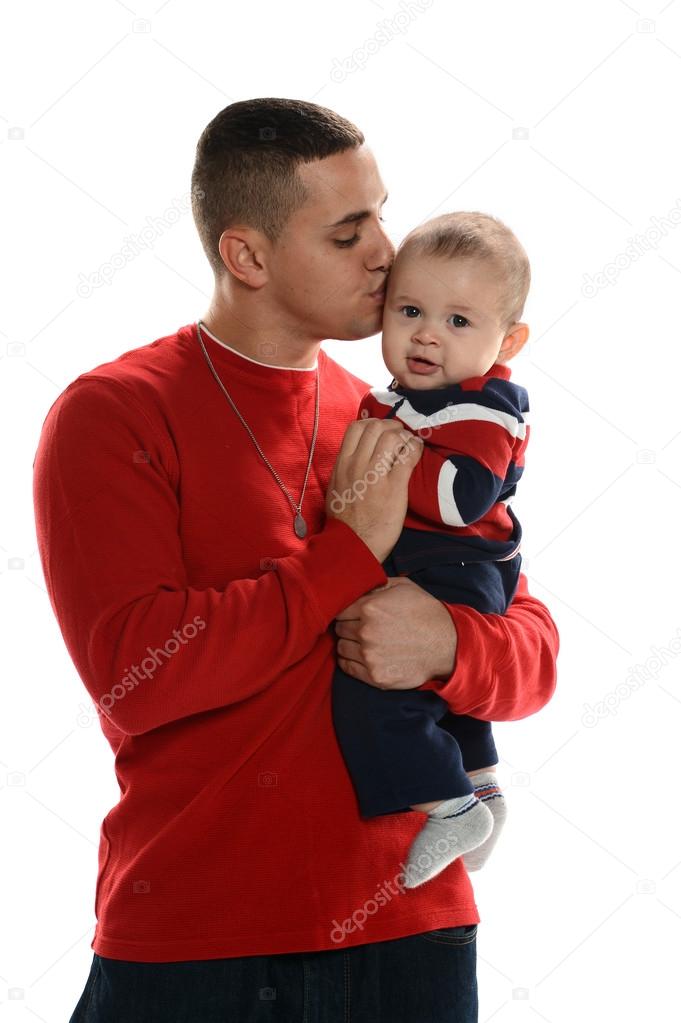 Young Hispanic father kissing his son