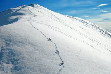 Alpinists climbing a mountain clipart