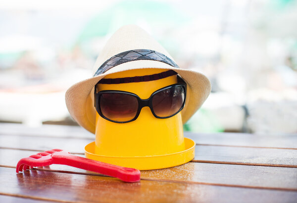 The Beach scene with bucket and sunglasses
