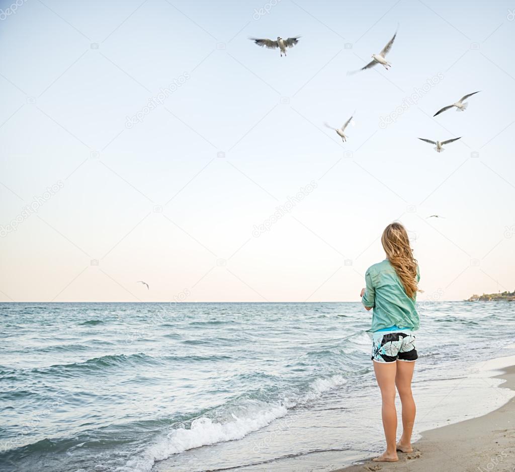 Young Girl are Feeding Seagulls