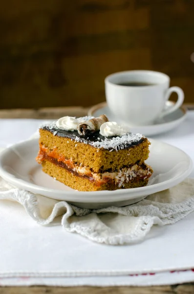 Sponge-cake with apricot jam in chocolate — Stock Photo, Image