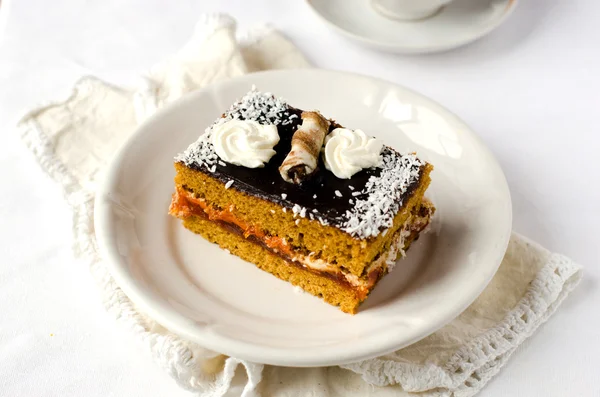 Sponge-cake with apricot jam in chocolate — Stock Photo, Image