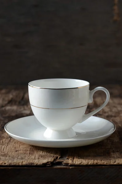 White cup on a wooden table — Stock Photo, Image