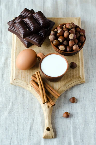 Milk, cinnamon, eggs, chocolate, and filbert — Stock Photo, Image