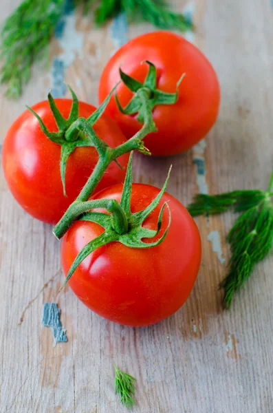Fresh tomatoes on a wooden table — Stock Photo, Image