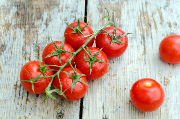 Fresh cherry tomatoes on a wooden table