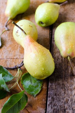 Tahta bir masada taze armutlar.