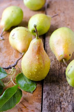 Tahta bir masada taze armutlar.