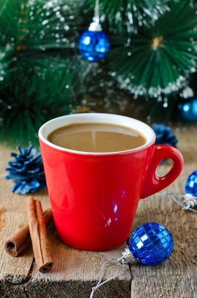 A cup of coffee on a wooden table with Christmas decorations — Stock Photo, Image