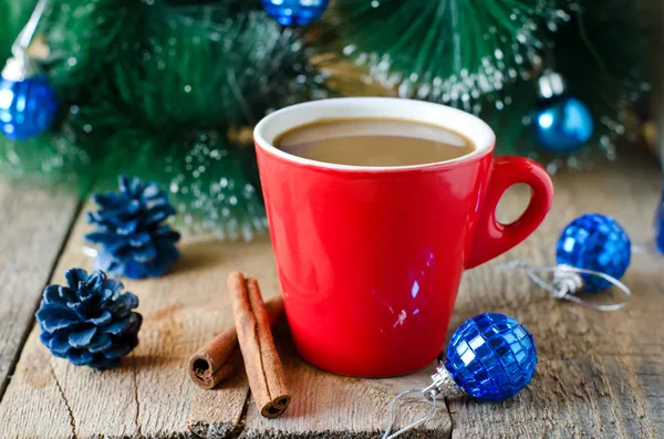 A cup of coffee on a wooden table with Christmas decorations — Stock Photo, Image