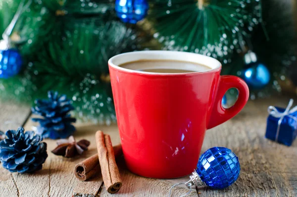 A cup of coffee on a wooden table with Christmas decorations — Stock Photo, Image