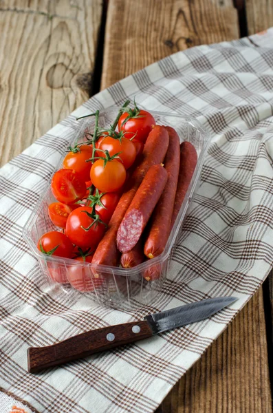 Smoked sausage and cherry tomatoes — Stock Photo, Image