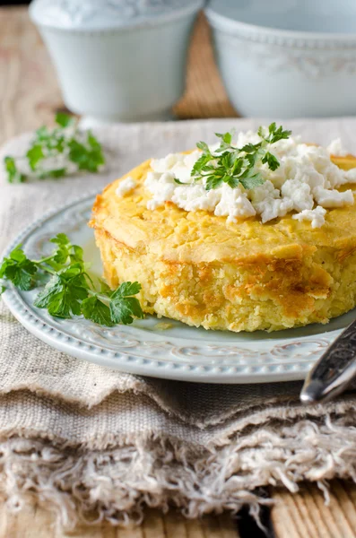 Cheese pie on a plate on a wooden table — Stock Photo, Image