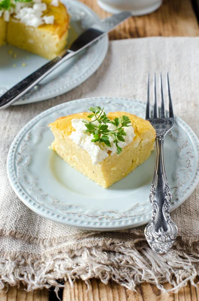 Cheese pie on a plate on a wooden table — Stock Photo, Image